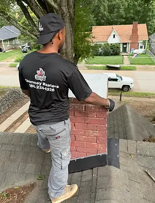 Chimney masters worker repairing a chimney cap.webp