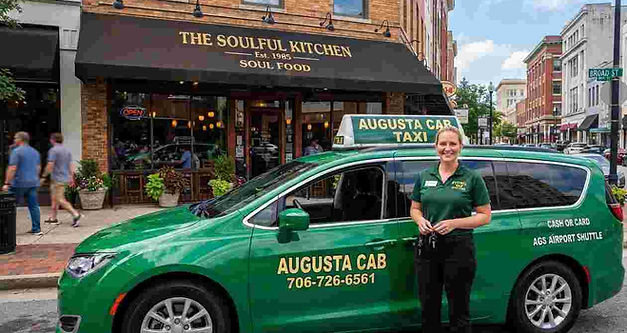 Augusta Cab green minivan in the street of Harlem, waiting for customers.