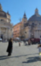 Piazza cittadina attraversata da bolle di sapone in una giornata di sole