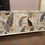 Thumbnail: Midcentury Sideboard. Leaf Print in White and Gold. Gold Handles and Pin Legs
