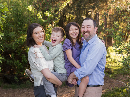 Family with grandparents and stuffed animals in a field