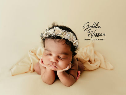 baby girl froggy pose yellow backdrop