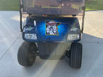 Front view of a golf cart with a custom wrap featuring a Minnesota Twins design from Mustang Signs and Graphics, showcasing team spirit.