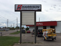 Lighted sign for Harrison Truck Parts in front of their store.