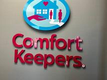 Indoor sign for Comfort Keepers with logo and branding.