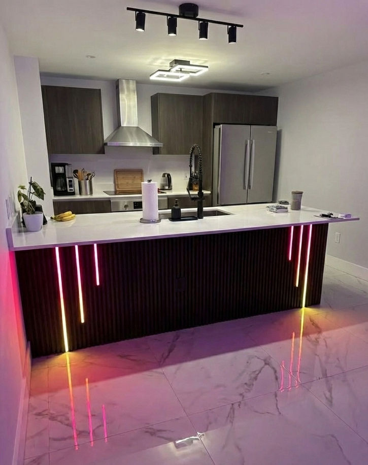 Black acoustic slat kitchen island wrap with vertical LED strip lighting. Modern kitchen remodeling and bar front design in Vancouver WA, Felida, and Camas.