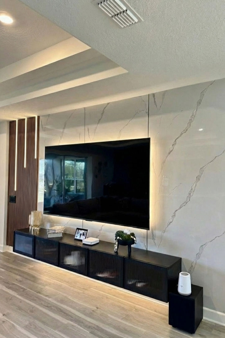 PVC marble sheet TV background wall with wood slats. Faux stone wall panel installer. Modern affordable luxury living room design in Camas WA, Vancouver WA, and Felida.