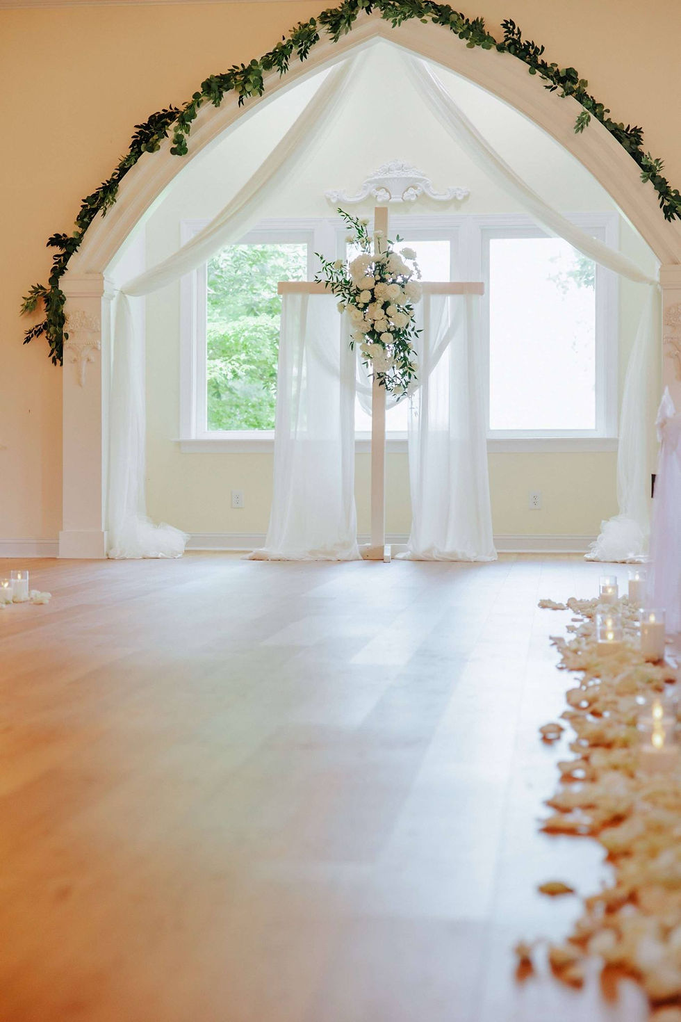 Eye-level view of a beautifully decorated white standing cross in the chapel