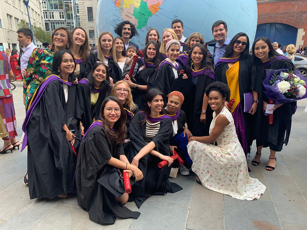 graduates from university embracing different cultures and global citizenship in front of a large globe