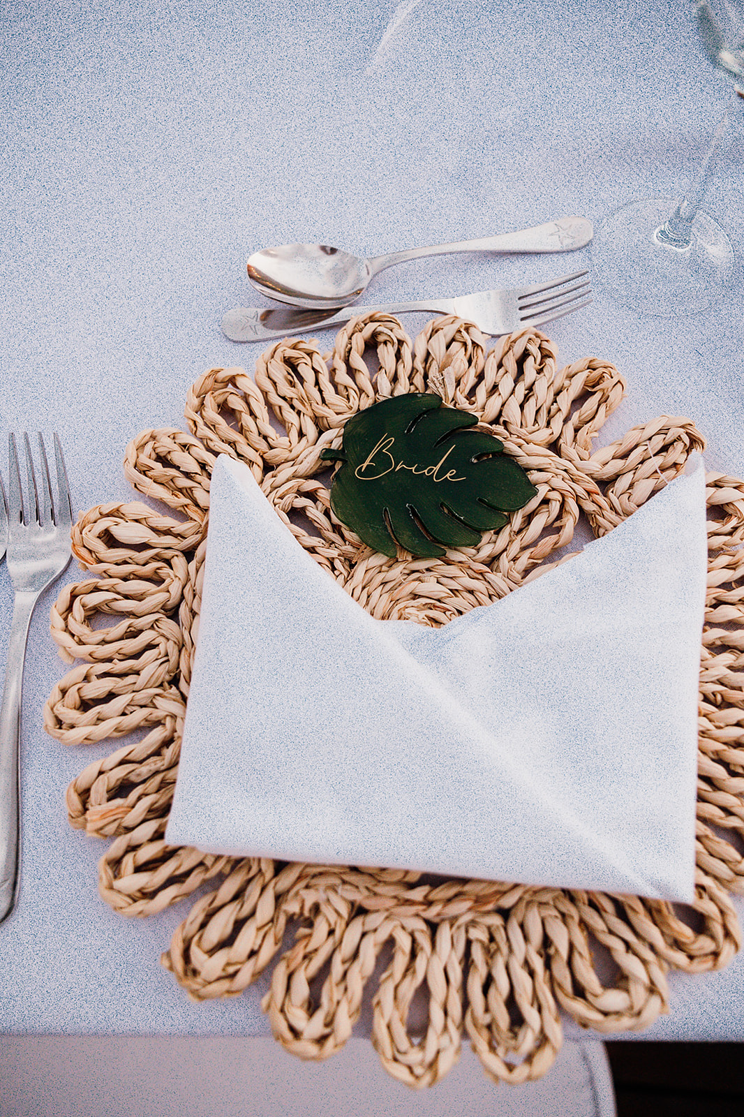 Reception plating with bride monstera leaf decoration and boho mat