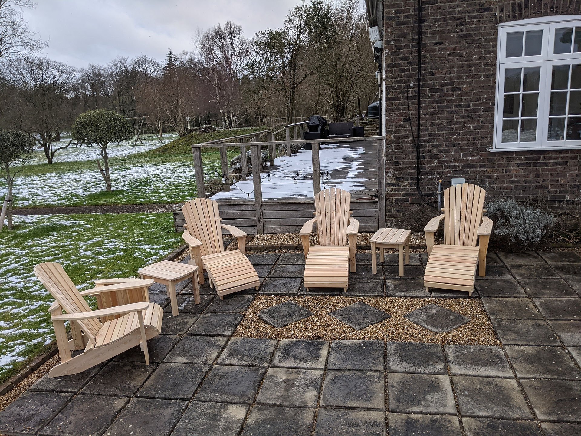 Four Adirondack Chairs with Footrests and Coffee Tables
