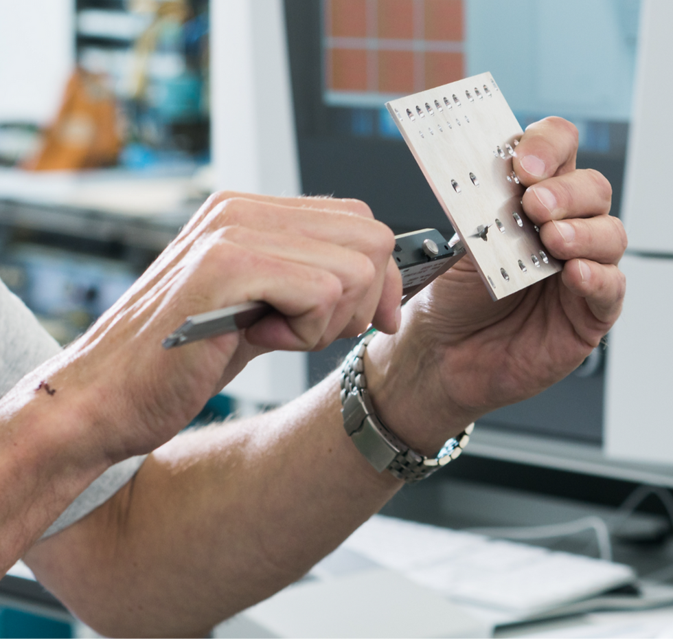 Mitarbeiter misst elektronisches Bauteil