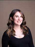 Smiling woman in black shirt poses for portrait, friendly and professional.