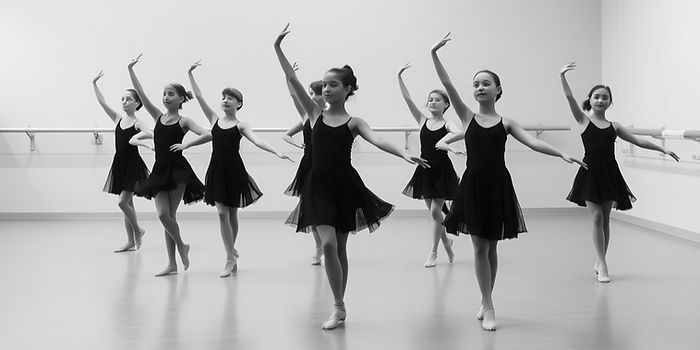 wide grayscale image of young dancers in a studio.jpg