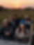 Woman wearing a blue crochet beret on a safari ride at sunset with friends in an open jeep
