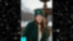 Video of a woman wearing a handmade green crochet beanie near a fountain in a snowy park