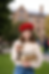 “Woman wearing Ruby Reverie red crochet beret holding books and coffee on campus”