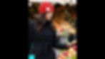 Video of stylish red crochet beanie with white flower worn by woman in winter market setting