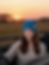 Model wearing a stylish blue crochet beret during a sunset safari adventure in nature