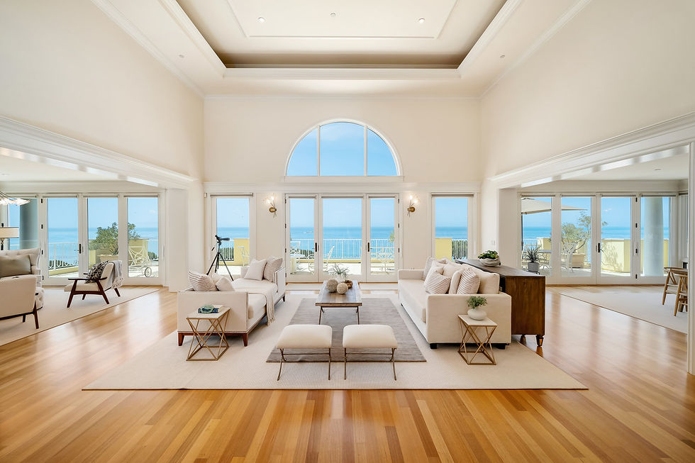 Bright great room with tall arched windows facing the ocean