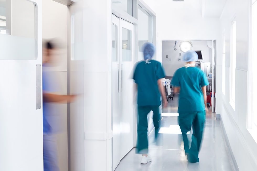 motion-blur-shot-medical-staff-wearing-scrubs-busy-hospital-corridor.jpg