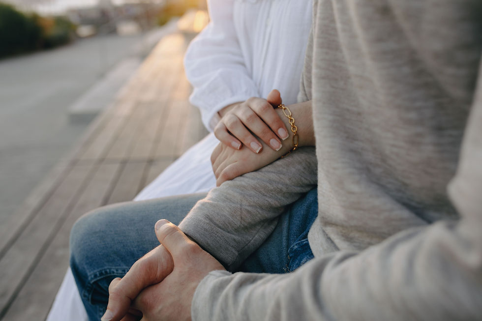 A Couple holding hands lovingly on there knees