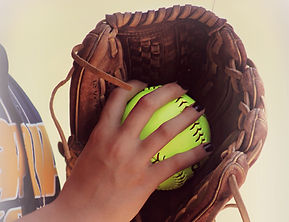 player holding softball in glove