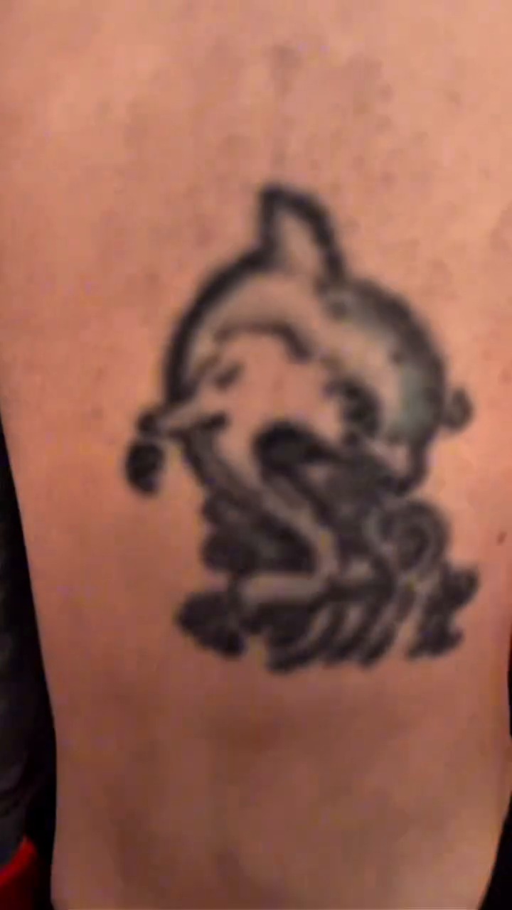Small tattoo with dark areas on the lower leg before the Stitch cover-up