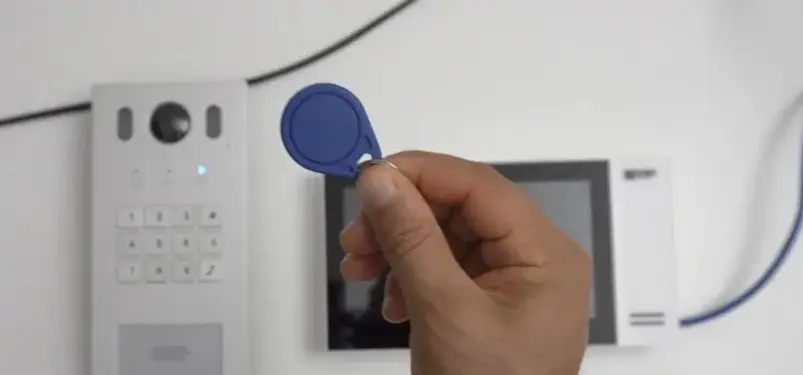 Blue-RFID-key-fob-shown-with-a-smart-access-control-system-for-demonstration.webp