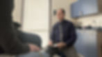 Dr Tom Bailey talking with a patient