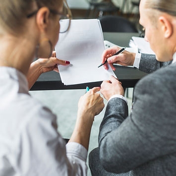 close-up-two-businesspeople-checking-document-restaurant.jpg