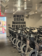 Indoor cycling class at SoulCycle Seaport with riders in a candlelit studio