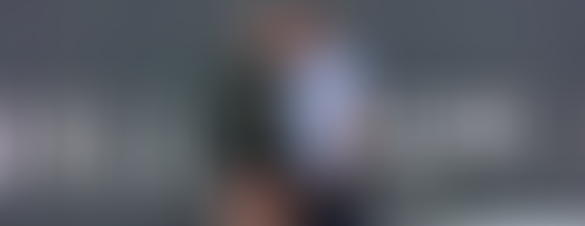 Kelly Whittaker-Cummings and Steve Sionne leading the Tall Ship Takeover workout with high energy on the Boston waterfront.