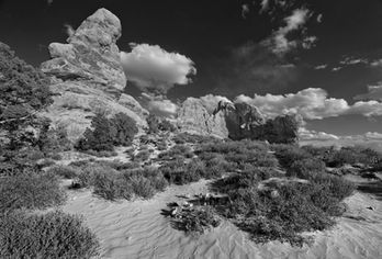 A black and white photograph of the Window Arch Trail in Arches National Park, Utah