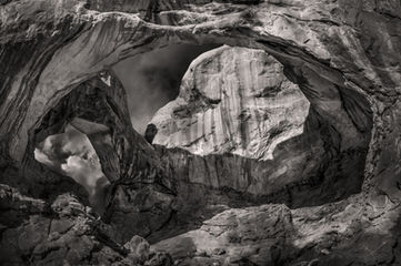 A black and white photograph of Double Arch in Arches National Park, Utah