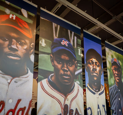 Portraits of famous baseball players hanging inside stadium