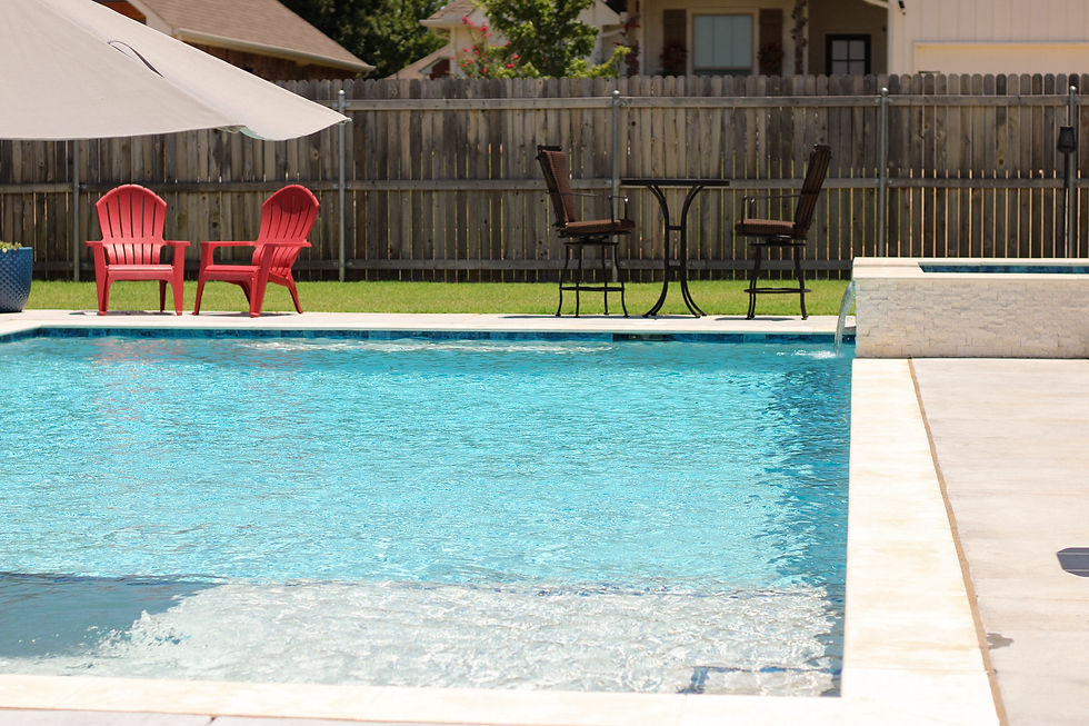 Custom inground gunite pool with hot tub and waterfall feature built by Signature Custom Pools in No