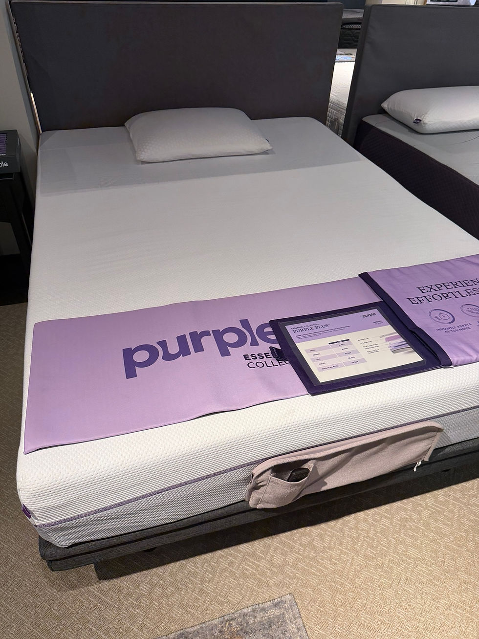 Purple mattress photographed in a retail showroom during Professor Goodsleep's testing.