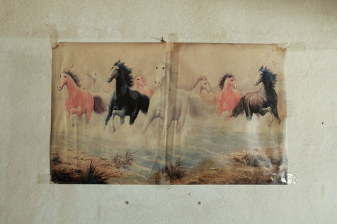 A replica of Feng Shui’s “eight galloping horses” painting is displayed at a local
restaurant outside the train station in Luang Prabang. In Chinese culture, the horses represent
courage, speed, and endurance, symbolizing success and the overcoming of obstacles. The
imagery of galloping horses is often associated with vitality and progress, reflecting a desire for
prosperity and growth. Laos, December 2021.