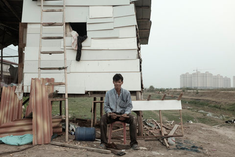 A farmer in front of his shack at That Luang marsh. Vientiane Capital, Laos. March 2021.