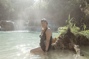 Chinese tourist from Beijing swimming at Khuang Si waterfall outside the World Heritage town of Luang Prabang, the main tourist destination in Laos. The number of Chinese and Thai tourists visiting Luang Prabang has increased significantly after the opening of the Lao-China Railway in December 2021. Laos, December 2024.