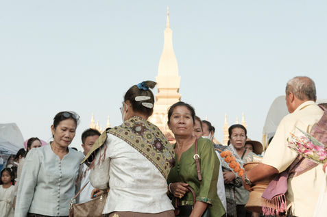Crowds gather around the That Luang Stupa in Vientiane during the annual That
Luang Festival, one of Laos’s most significant cultural and religious events. Held every
November, the festival honors the revered golden stupa, believed to house a relic of the
Buddha. In a country where the majority of the population practices Theravāda Buddhism,
the festival is a deeply spiritual occasion. Festivities include almsgiving, processions, and
cultural performances, drawing thousands of devotees and visitors from across Laos.Laos,
November 2022.