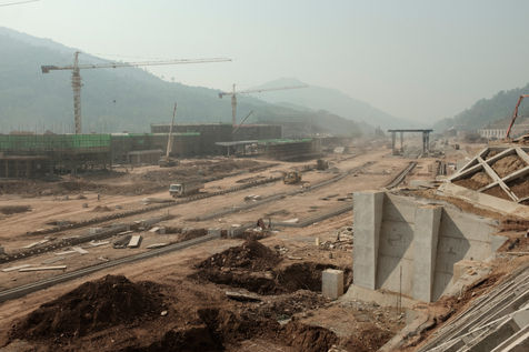 The construction of Boten train station 2Km south of the city. The train station part
of the Belt and Road Initiative (BRI), was officially inaugurated in December 2021. Coming
from China, Boten is the first railway stop in Laos, thus destined to become an important
logistical and economic hub. What was a rural village counting a few thousand inhabitants
less than twenty years