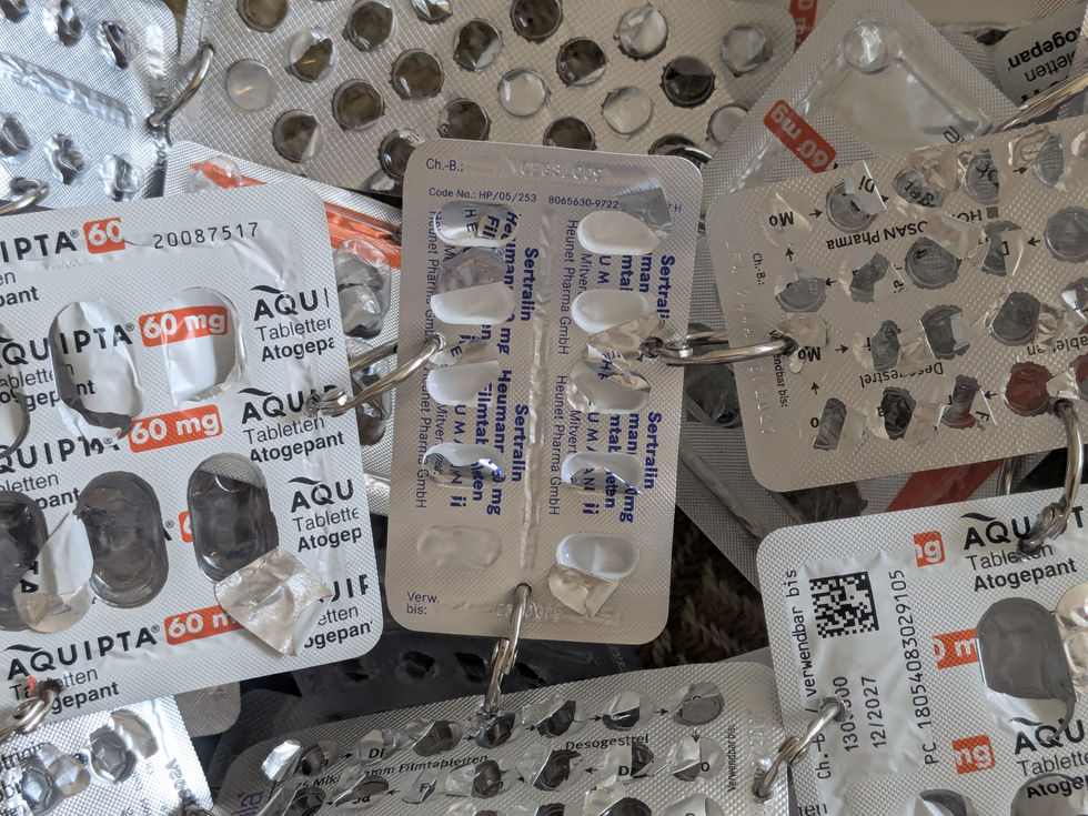 You can see various tablet blisters connected by metal rings.