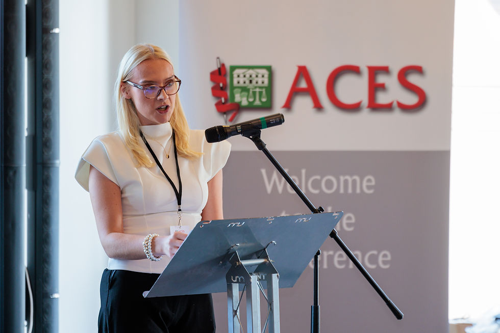 Alicia Gristwood speaking at the podium microphone during her mini-keynote on future workforce issues.