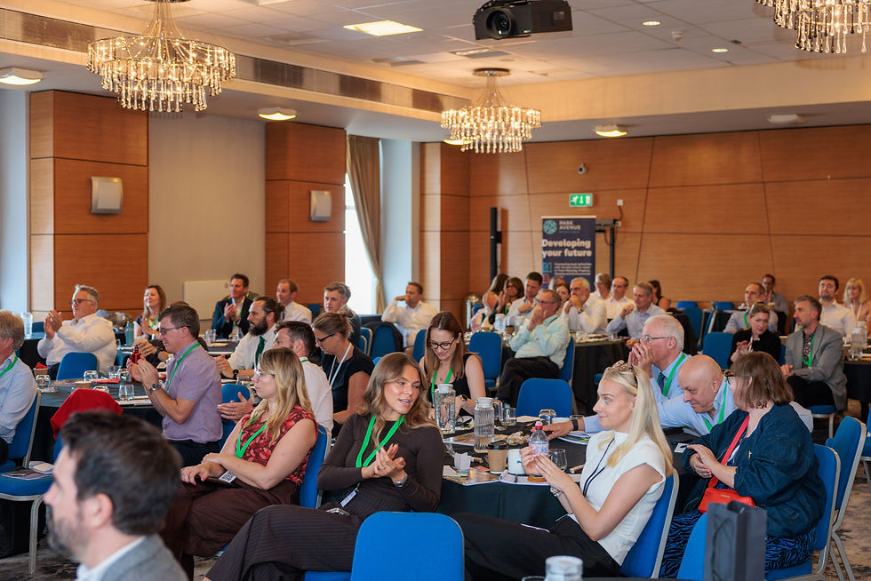 Audience of property professionals applauding during a presentation session at the ACES National Conference.