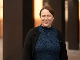 Portrait of Victoria Yeandle, a chartered town planner, standing in a modern architectural setting.
