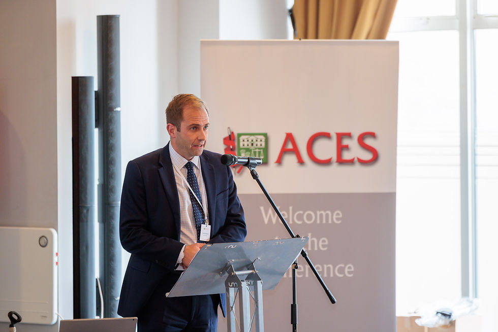 David Johnson presenting at the lectern microphone during the Carter Jonas UK property market session.