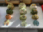 Hand sculpted frogs that were later hung together as a wind chime