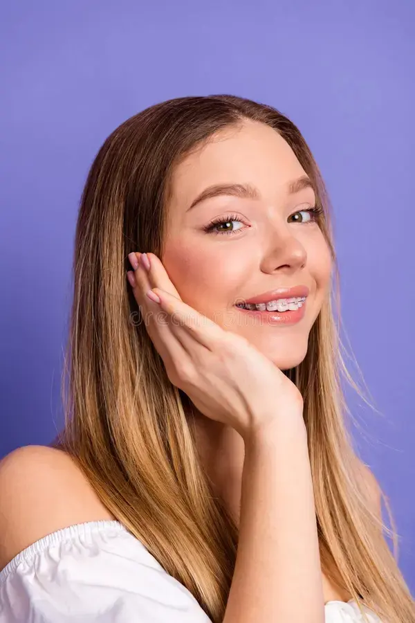 beautiful-blonde-woman-displaying-cheerful-expression-showcasing-her-braces-posing-vibrant